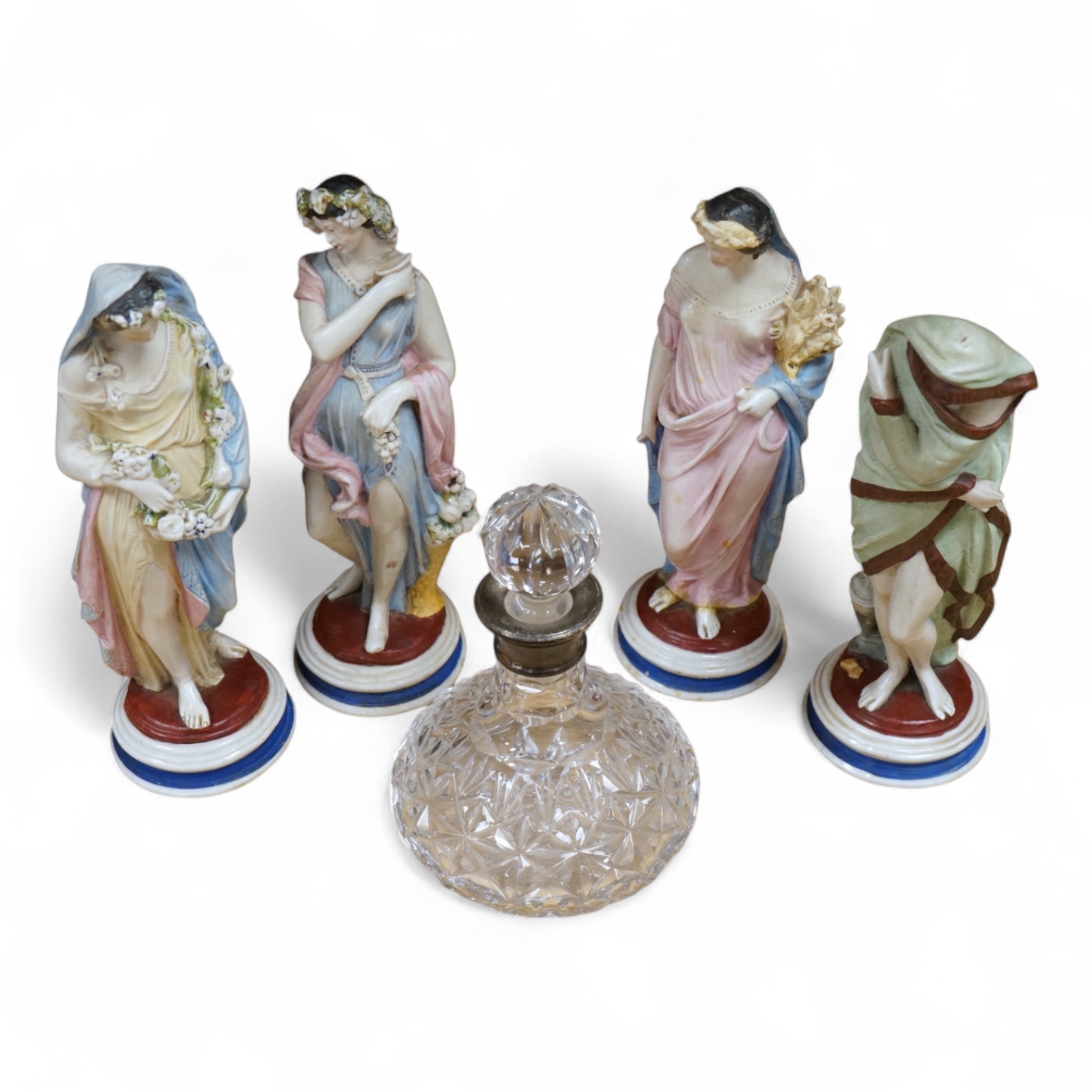 A set of four painted biscuit porcelain figures of The Seasons, and a silver-mounted scent bottle, figures 24cm